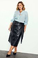 Thumbnail for Black vegan leather Jaspre wrap skirt with a tulip-shaped tie, styled with a light blue shirt.