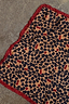 Cherry Leopard Bandana featuring a leopard and cherry print and a deep red ruffle border, shown laid flat.