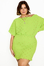 Model wears the Lime Plisse Mini Tilly Dress featuring gold foil spots and textured fabric.