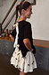 Thumbnail for Black Bow Mini Monika Skirt in white pleated tulle mesh with tiny black bow embellishments.
