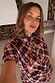 Chocolate check floral top with a high neck and draped sleeves on a model wearing UK size 18.