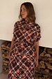 Chocolate brown check floral top with a high neck and draped sleeves, worn with a matching co-ord skirt.