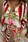 Cirque Miley Shirt in a multi-coloured sun and star print, styled as a co-ord with matching trousers.