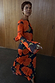 Black Poppy Aria Mesh Dress Petite featuring orange floral poppy prints and flared sleeves.