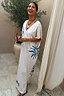Thumbnail for Cream Dolce Vita T-Shirt Dress with blue hand-painted sun motifs and Greek graphics on a laughing model.