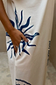 Cream Dolce Vita T-Shirt Dress in cotton with blue sun motifs and a side pocket.