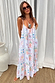 Model wearing the White Island Cross Stitch Maxi Dress featuring a colourful tropical print and rope strap detailing.