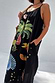 Thumbnail for Black Rio Maxi Dress featuring the tropical Rio print and thin straps, styled for summer with a woven bag.