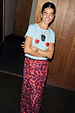 Red Cherry Mesh Dorris Skirt with a vibrant cherry print, styled with a blue graphic tee and designed in London.