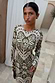 Olive Amara Plisse Gaia Dress with a green heart, eye and floral print in a stretchy, long-sleeved plisse style.