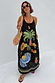 Thumbnail for Black Rio Maxi Dress with hand-painted tropical fruit motifs and thin straps, styled with a crochet bag and sunglasses.