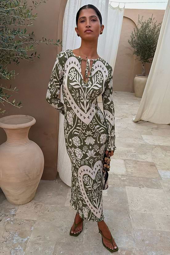 Olive Amara Plisse Gaia Dress featuring cream heart and floral motifs on green pleated fabric.