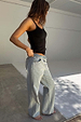 Black Teddy Vest with mesh trim at the neckline, paired with light-wash wide-leg scallop jeans on a model.