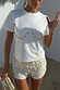 Thumbnail for Cream Shells Hot Pants with pearlescent shell beads and a matching tee, designed in London for vacation.