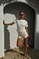 Thumbnail for Cream Shells Hot Pants with pearlescent shell beads and glass beading, styled for a beach vacation look.