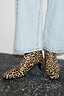 Thumbnail for Leopard Heel Boots with a square toe and thin block heel, styled with light-wash blue jeans.