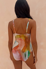 Abstract Plunge Swimsuit in painterly sunset tones, highlighting the back design and adjustable straps.