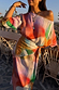 Multi-wear Abstract Scarf styled as a waist tie on a matching dress to create a colourful dopamine dressing look.