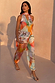 Abstract Naomi Trousers in a bold multicoloured print featuring a balloon leg and adjustable ankle ties.