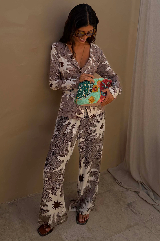 Chocolate Soleil Ellie Trousers and Alex Cardigan co-ord featuring a sun motif print and line detailing.