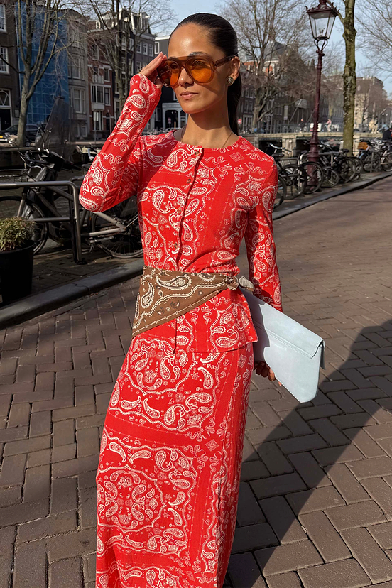 Red Bandana Alexa Cardigan in a ribbed knit with an iconic print, styled as a co-ord set with a matching skirt.