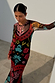 Black Amara Mesh Dress with vibrant hand-painted heart and eye motifs on a long-sleeved, stretchy mesh silhouette.