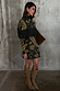 Olive Amara Knit Mini Dress featuring a fringe chest detail and gold motifs, styled with slouchy tan boots.