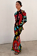 Black Amara Dorris Skirt with vibrant hand-painted heart and eye motifs, styled with a matching cardigan.
