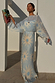 Blue Soleil Anais Dress with Mediterranean sun motifs, a sheer draped top and a flowing satin-esque maxi skirt.
