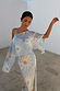 Blue Soleil Anais Dress with a Mediterranean sun print, sheer off-the-shoulder top and long bias cut skirt.