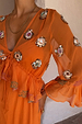 Apricot Embellished Ines Dress in orange sheer fabric with hand-embroidered mirror detailing and a ruffled peplum.