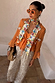 Apricot Embellished Top in orange with mirror details, tie waist and frill sleeves, paired with silver sequin trousers.