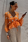 Apricot Embellished Top featuring mirror embroidery and a peplum hem, styled with silver sequin trousers.