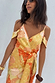 Apricot Strappy Vienna Dress featuring orange tones and golden accents in a multi-wear wrap style.