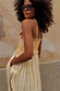 Yellow Stripe Ashley Dress with sun motifs, frilled trims and side pockets in a cotton-linen blend on a model.