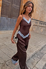 Chocolate Aurelia satin-esque top with blue lace trim, styled with matching trousers on a model walking outdoors.