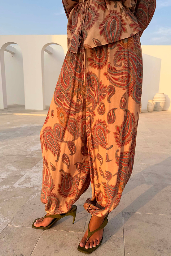 Close up of peach Paisley Balloon Trousers in a lightweight and breathable balloon silhouette.