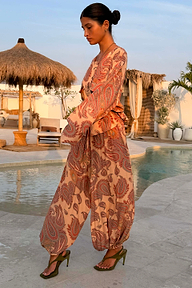 Peach Paisley Balloon Trousers and matching top styled as a co-ord in a poolside vacation setting.