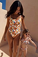 Girl's Banana Bikini in a multicoloured print with a ruffled top and bottoms, styled for family matching on vacation.