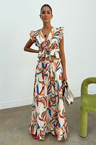 Banana Saige Skirt in a multicolour banana print with tiered panels and a frill hem, styled as a cotton co-ord set.