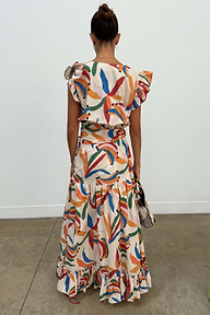 Banana Saige Skirt in a multicolour banana print with a tiered frill hem, styled as a cotton co-ord from behind.