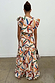 Banana Saige Skirt in a multicolour banana print with a tiered frill hem, styled as a cotton co-ord from behind.