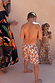Boy's cream banana print swim shorts with a multi-coloured pattern, part of a matching family vacation set.