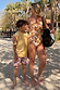 Boy’s cream Banana Print Swim Shorts and yellow tee, paired with a matching woman’s swimsuit for a family vacation.