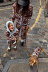 Chocolate Bandana Dog Jumper on a pup, styled with matching family knitwear on a cobbled London street.