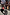Thumbnail for Red and Pink Bandana Dog Jumper with iconic print on a black dog on a London cobblestone street.