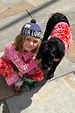 Red and Pink Bandana Dog Jumper on a black dog, paired with a matching kids' bandana print knitted set.