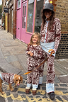 Chocolate Bandana Wide Leg Trousers in a matching brown and blue knit co-ord on a woman, child, and dog.