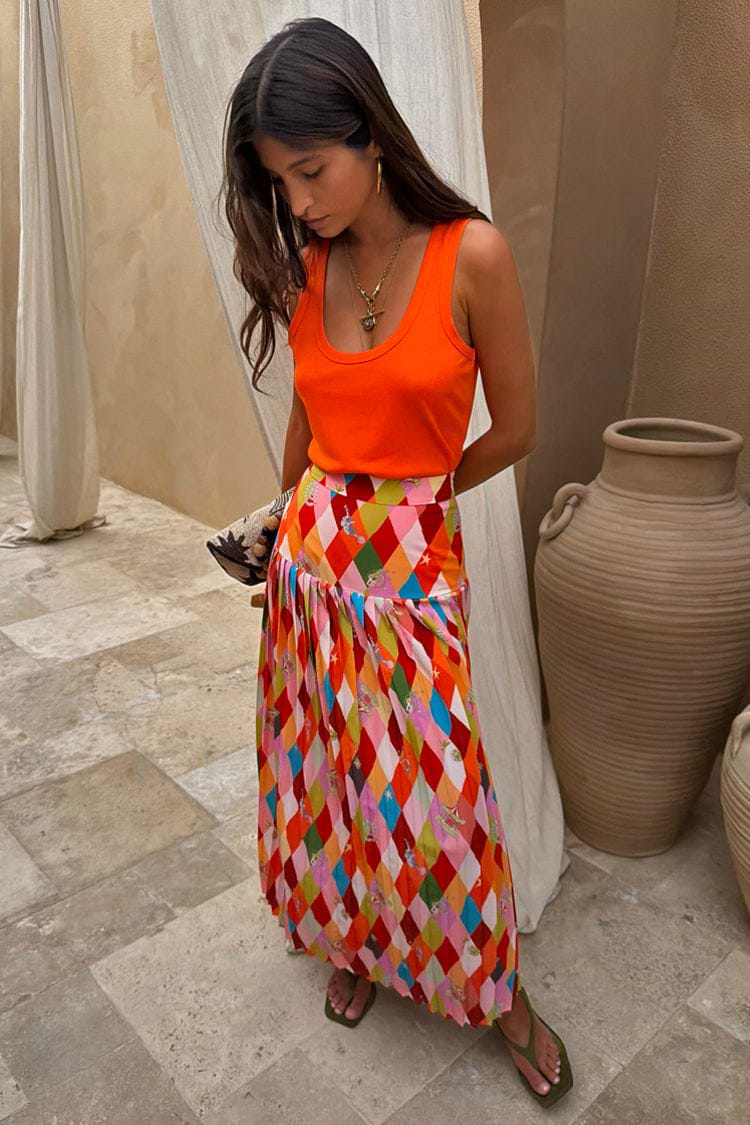 Cirque Beatrice Skirt featuring a multi-coloured geometric harlequin print and a pleated A-line silhouette.