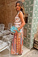 Pleated Dolce Vita Freya Skirt in a multi-coloured tile patchwork print, styled as a vacation-ready co-ord.